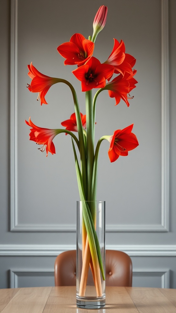 A tall arrangement of bright red amaryllis flowers in a clear glass vase on a wooden table.