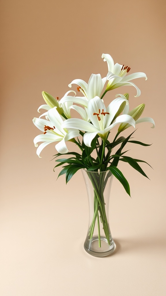 A classic white lily arrangement in a clear glass vase on a plain background.